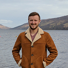 engineering student, ryan, standing in front of a lake