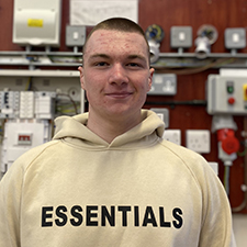 sam standing in the workshop