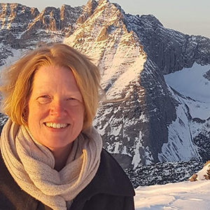 katherine standing in front of a mountain with snow