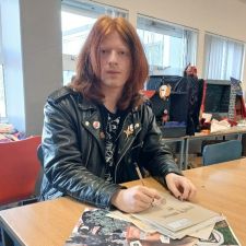 Ewan sitting a classroom desk