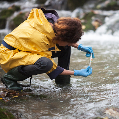 Student taking samle from a river