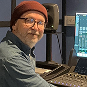 Audio engineering student sitting in front of a audio mixing table