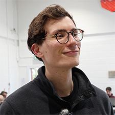Ian standing in the webster building on campus