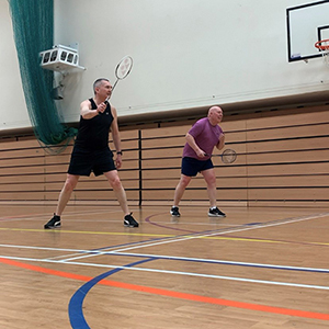 two people playing badminton