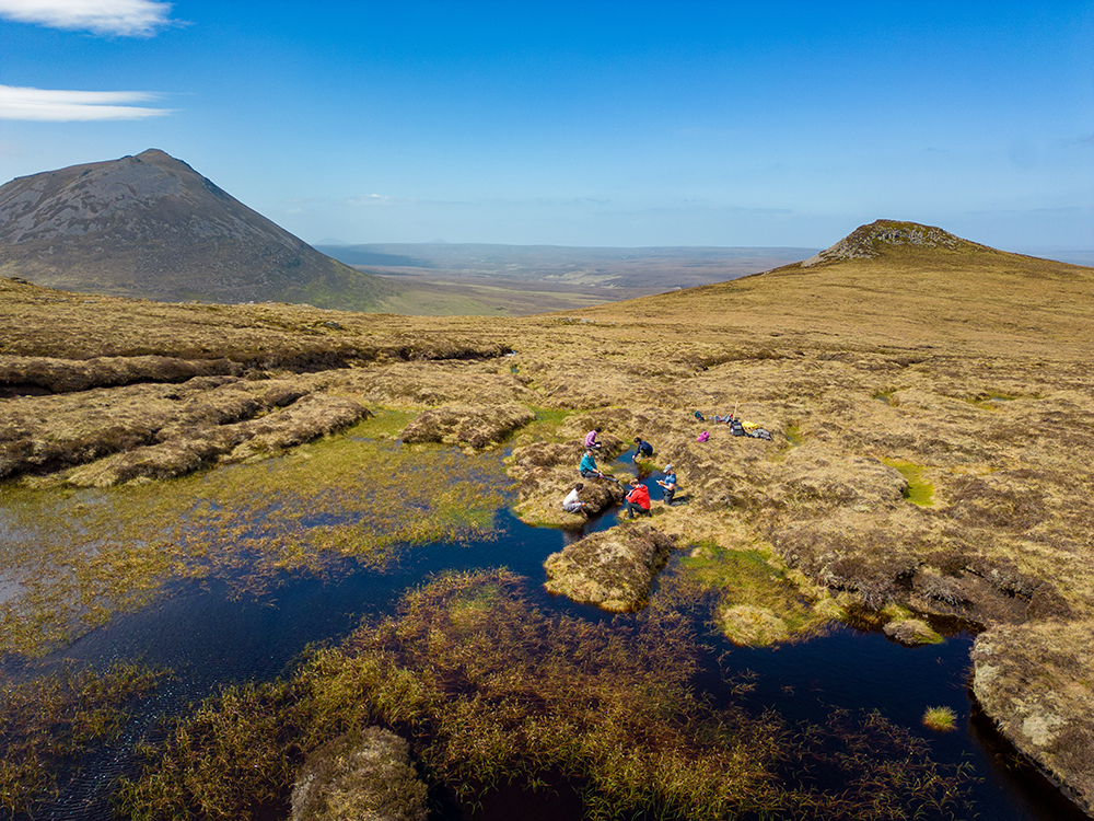 Researchers from the Environmental Research Institute water sampling at Braemore Estate Caithness looking towards Morven